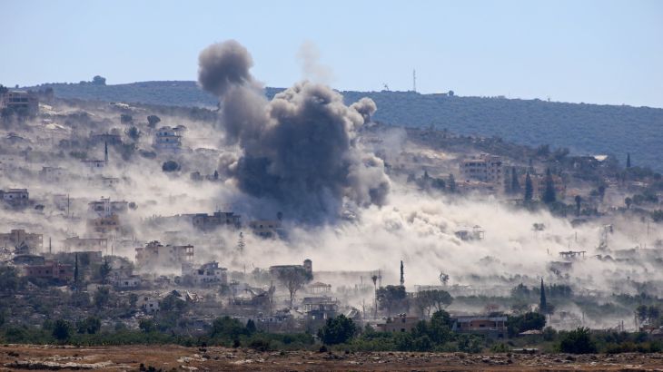 Smoke rises from the site of an attack on a village.