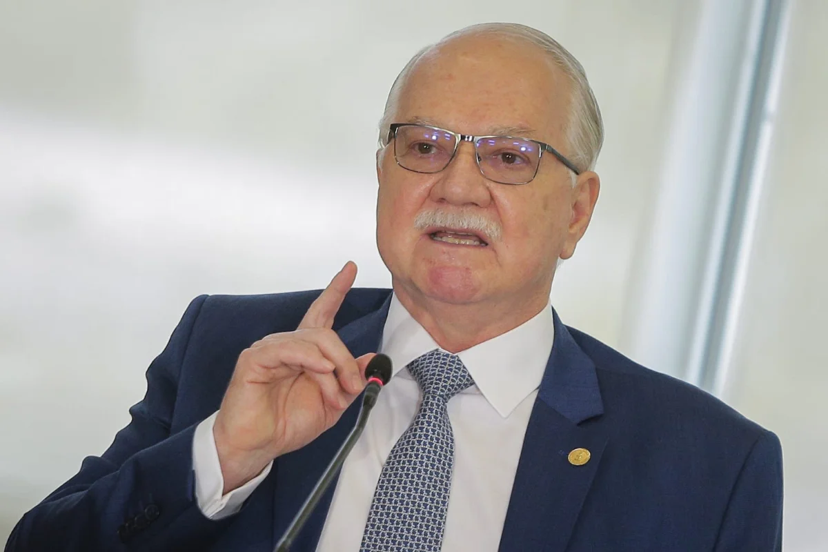 Edson Fachin com o dedo levantado em frente à parede branca
