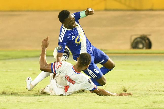 Daniel Green of Mount Pleasant is brought down by Steven Young of Portmore United during their 2026 Concacaf Caribbean Cup football match at the National Stadium on Wednesday night. Mount Pleasant won 1-0. - Ian Allen photo